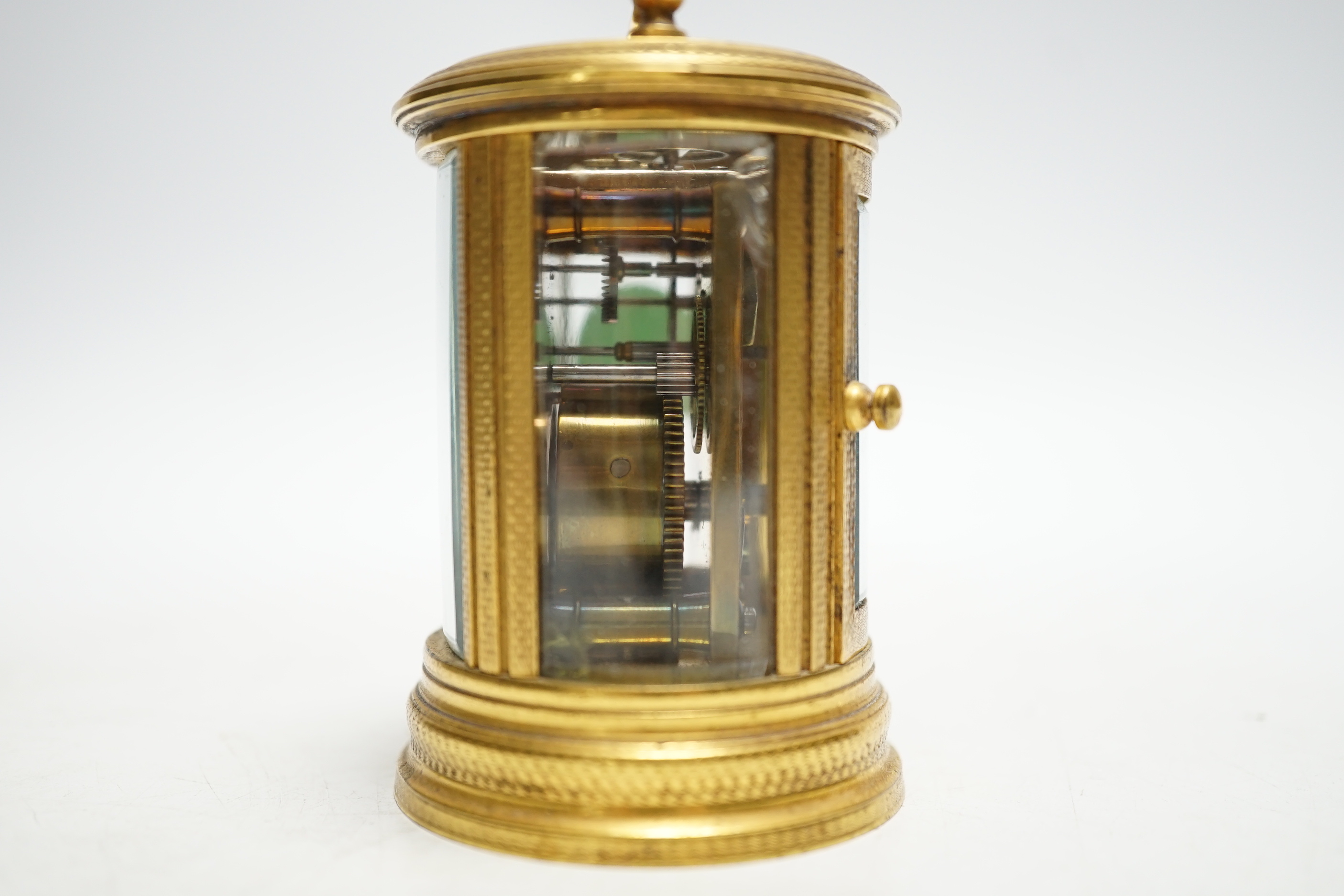 A late 19th French miniature engraved oval cased carriage timepiece, height 7cm